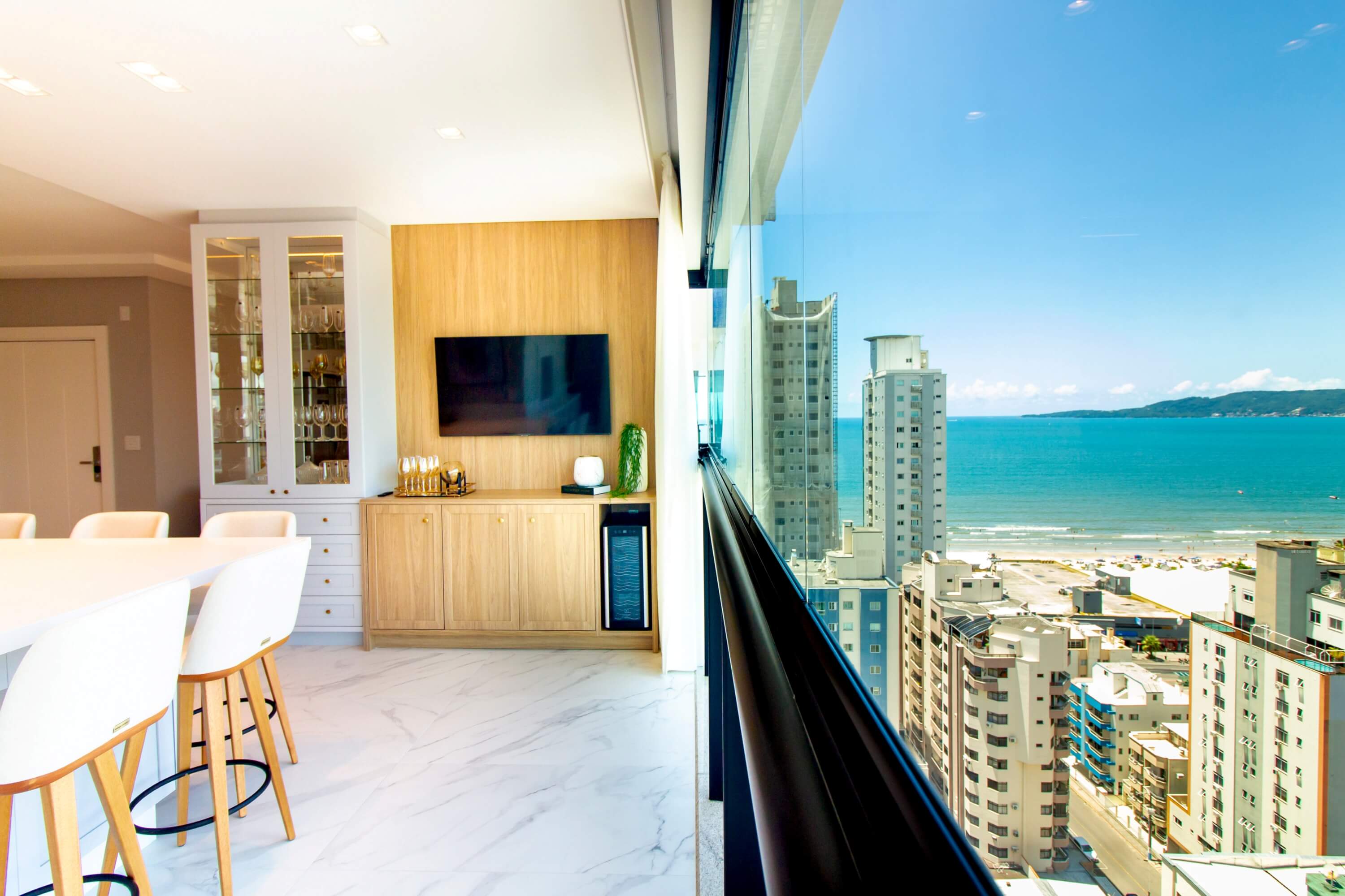 Beautiful vacation rental living room, welcome basket with QR code card, beach/mountain view through window.